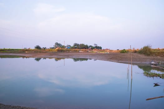 Arial View Canal with green grass and vegetation reflected in the water nearby Padma river in Bangladesh