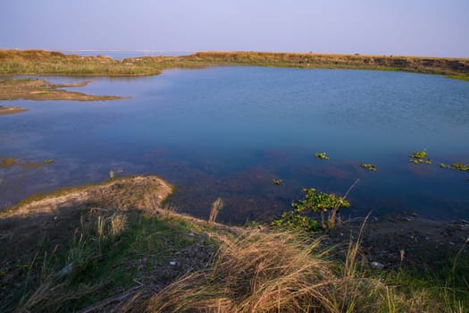 Crystal clear blue water lake landscape view nearby Padma river in Bangladesh
