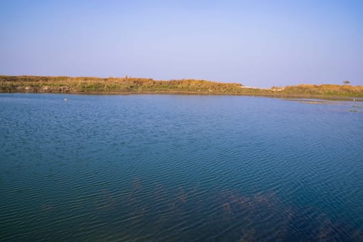 Crystal clear blue water lake landscape view nearby Padma river in Bangladesh