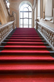 Turin, Italy - January 2023: Palazzo Barolo staircase. Luxury palace with old baroque interior and red carpet