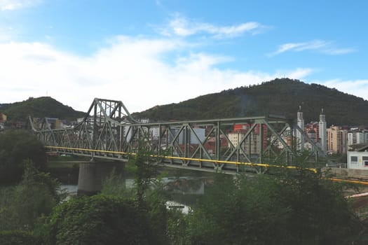 Zvornik, Bosnia and Herzegovina, Mali Zvornik, Serbia, September 29 2022 Drina river. Metal bridge across the Drina. Border point. View of coasts Serbia and BiH. Residential houses and Orthodox Church
