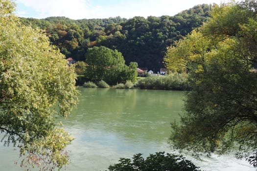 Mali Zvornik, Serbia, September 29, 2022. Drina river near Banja Koviljaca, view of the coast of Serbia from BiH. The flow of water, greenery on the opposite bank of the river. Residential houses