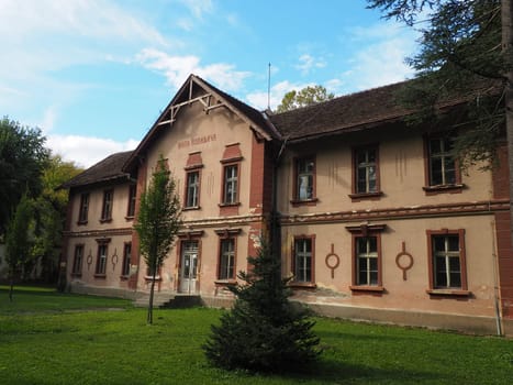 Banja Koviljaca, Serbia, Guchevo, Loznica, September 30, 2022. Rehabilitation center with sulfur and iron mineral waters. Old unrestored two-story villa buildings with a lawn, Banja Koviljacha.