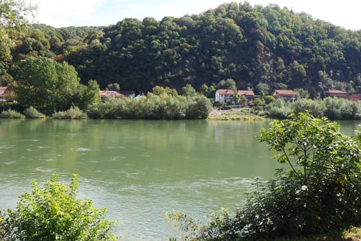 Mali Zvornik, Serbia, September 29, 2022. Drina river near Banja Koviljaca, view of the coast of Serbia from BiH. The flow of water, greenery on the opposite bank of the river. Residential houses