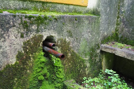 Banja Koviljaca, Loznica, Serbia. Mount Guchevo, park and forest. Source of mineral sulfuric and ferruginous water Rakina Chesma Cesma. A spring near the road to Guchevo. Concrete fence and stairs
