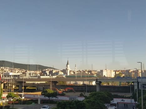 Istanbul Turkey, Sabiha Gokcen Airport Uluslararasi Havalimani 04.08.2022 view from window on Istanbul through the glass. Earthquake resistant high-rise buildings, new roads, transport and a mosque