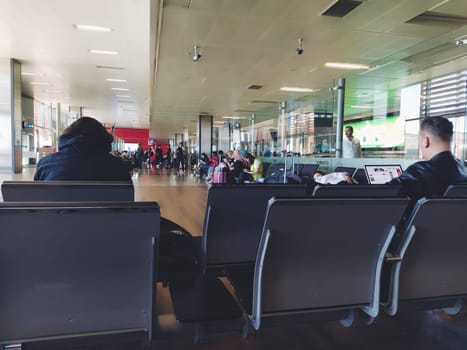 Istanbul Turkey, Sabiha Gokcen Airport Uluslararasi Havalimani 04.08.2022 The waiting room at the airport for stay of passengers. People passengers waiting to board the flight. Airport interior.