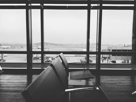 Istanbul Turkey, Sabiha Gokcen Airport Uluslararasi Havalimani 04.08.2022 The waiting room at the airport for stay of passengers. Empty benches. Huge glass windows. View of the runway. Waiting flight
