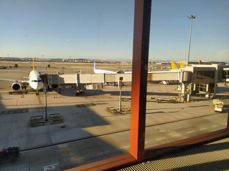 Istanbul, Turkey, Sabiha Gokcen Airport Uluslararasi Havalimani 07.15.2022 view from the window of the passenger terminal on the runway area. Airplane bridge. Suitcases disembark from the plane.