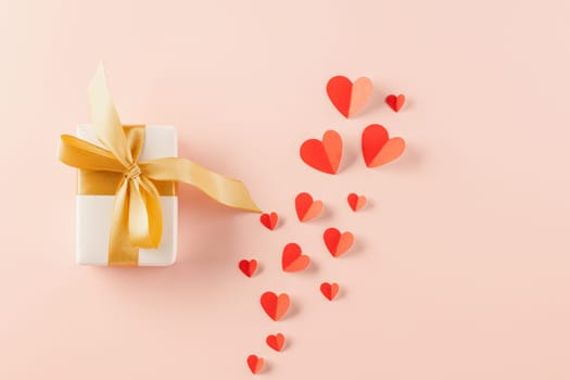 Top view flat lay of paper hearts and gift box on pastel pink background surprise your loved with space for text, birthday greeting, web design banner holiday, Happy Valentine Day Background