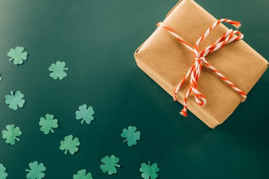 Happy St Patricks Day decoration background. above view gift box green clover leaves festive decor, shamrocks leaves holiday symbol with copy space on green background, Banner greeting card concept
