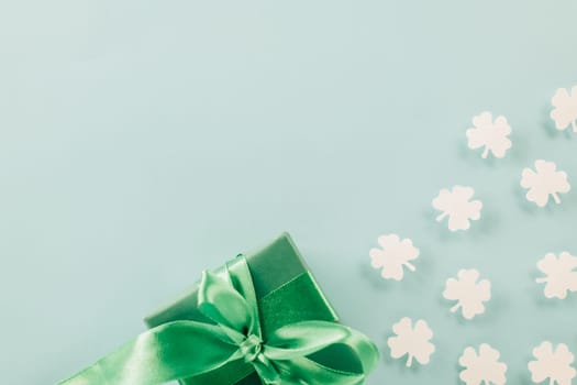 St Patricks Day decoration background concept. shamrocks leaves holiday symbol with copy space on pastel background, above view gift box green clover leaves festive decor, Banner greeting card