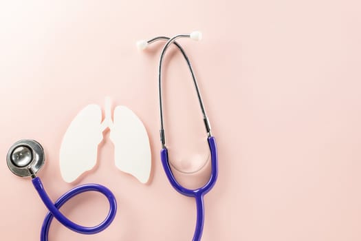 World Tuberculosis Day. Overhead lungs paper symbol and medical stethoscope on pink background, lung cancer awareness, copy space concept of world TB day, banner background, pneumonia awareness