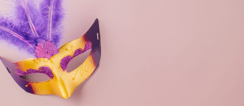 Venetian mask, Carnival mask for Mardi Gras celebration isolated on purple background banner design with copy space, jewish holiday, Purim in Hebrew holiday carnival ball, Happy Purim carnival concept