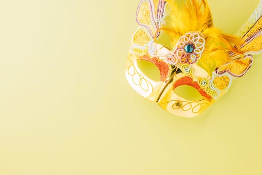 Happy Purim carnival accessories. Top view carnival mask for Mardi Gras celebration isolated on pastel green background, jewish holiday, Purim in Hebrew holiday