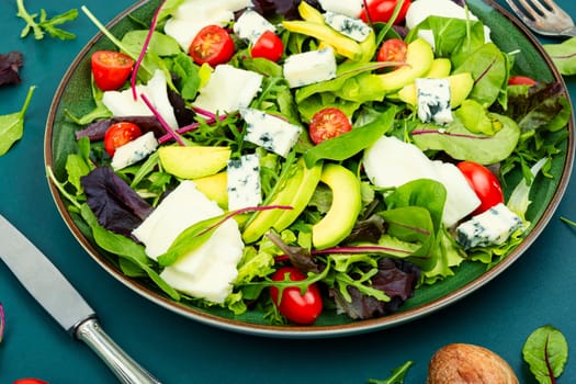 Salad with fresh lettuce, greens, avocado, tomatoes and cheeses. Space for text.