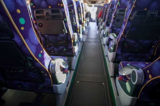 Tourist bus interior. Seats lines seen from back