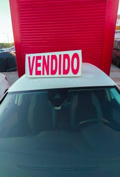 Second-hand cars with sold sign over. Boom in the purchase of used cars in Spain