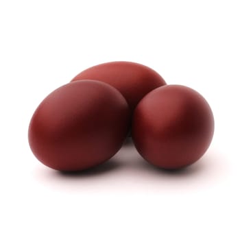 Three Easter eggs painted with onion peel, isolated on white background
