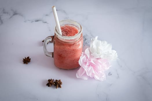 strawberry fresh Smootie on a marble table ready to be eat