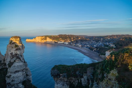 view of the beach of Etretat in Normandy, a popular french seaside town known for its chalk cliffs