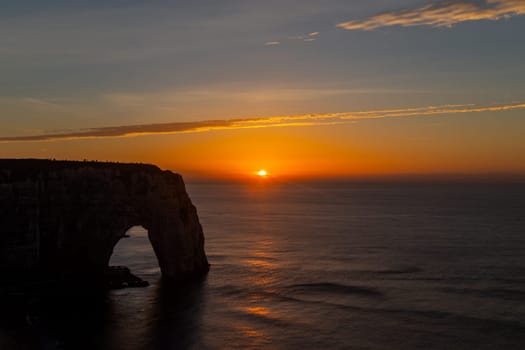 Dramatic sunset on the coast in Etretat, France. Etretat is a charming town famous for the stunning cliffs of Etretat on the Alabaster Coast