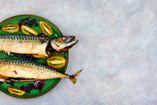 Whole mackerel fish baked with kiwi fruits. BBQ grilled mackerel fish