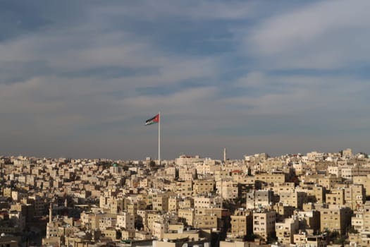 Jordanian Flag over the skyline of Amman, Jordan 2021
