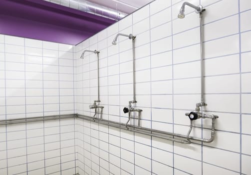 Interior detail of some showers in a gym, sport and hygiene