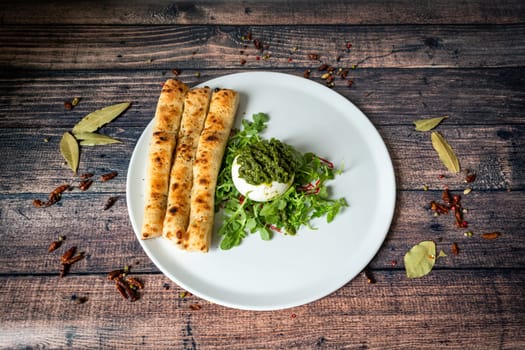 Plate of foccacia and burrata on a wooden table