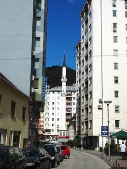 Zvornik, Bosnia and Herzegovina 1 October 2022 Old Rijeka Mosque, also known as Hadzi-Mahmud Mosque. Religious Muslim mosque with a tower. City streets with cars and people in summer in sunny weather.