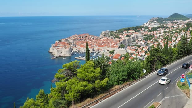 Road traffic near Dubrovnik old town in Croatia. Dubrovnik Ragusa is a city in Croatia, the administrative center of the Dubrovnik-Neretva County. Top view from the observation deck on the rock