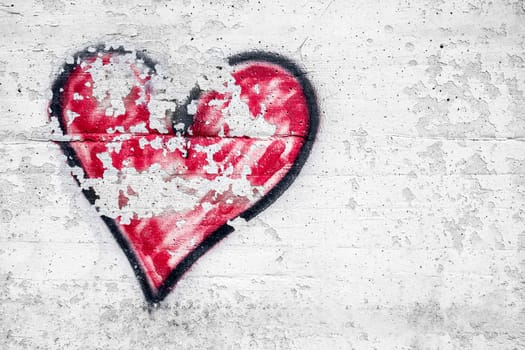 Big black and red heart, painted on the wall with spray paint, a symbol of love. Valentine's day.