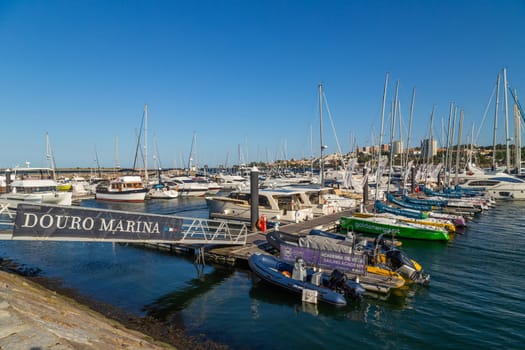 Porto, Portugal - July 7, 2022: Douro Marina, small boats in the port of Afurada at the exit of the mouth of the Douro river