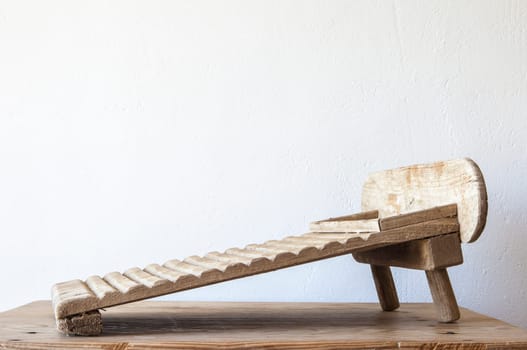 Old wooden washboard. Displayed over wooden table