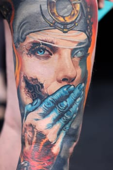 Krakow, Poland - June 12, 2022: Unidentified participant during the contest for the best tattoo at the 15th Tattoofest Convention in Cracow. One of the most prestigious tattoo festivals.