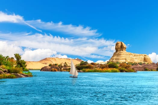 Lonely sailboat in the Nile on the way to the Great Sphinx, Aswan landscape, Egypt.