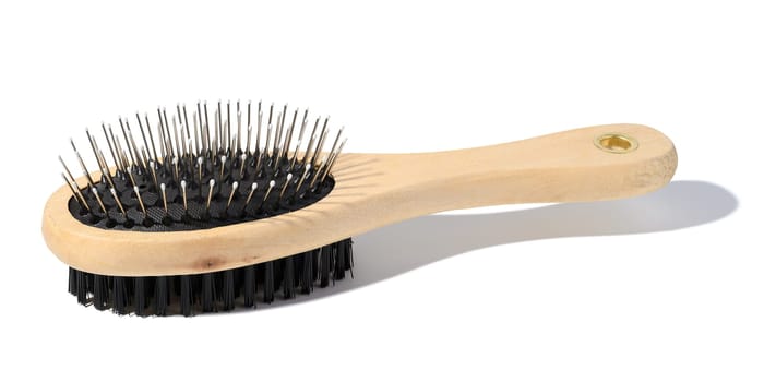 Wooden brush for animals on a white isolated background