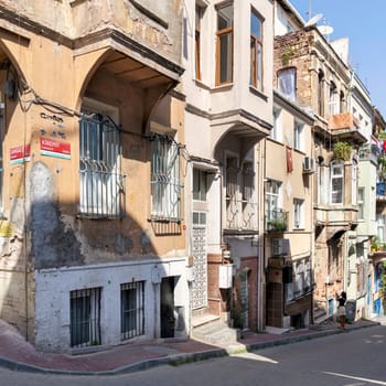 Cobblestone alley with beautiful old traditional houses in old Balat district, on a summer day, Istanbul, Turkey