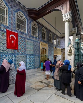 Istanbul, Turkey - September 1 2022: People praying in front of the tomb of Abu Ayyub al-Ansari at Eyup Sultan Mosque