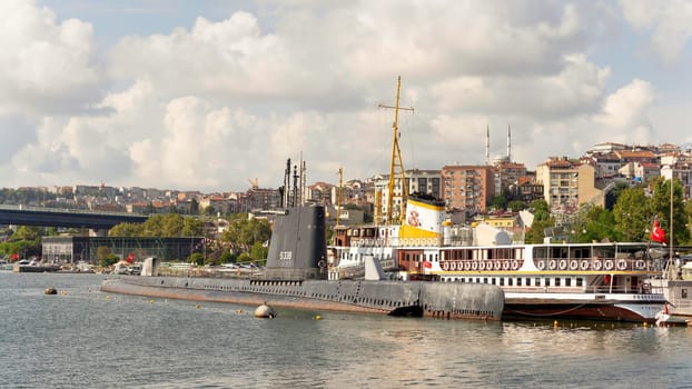 View of Golden Horn, with S 338 submarine, Fenerbahce ferry boat, and Golden Horn Bridge in the far end, Halicioglu Neighborhood of Beyoglu district, Istanbul, Turkey