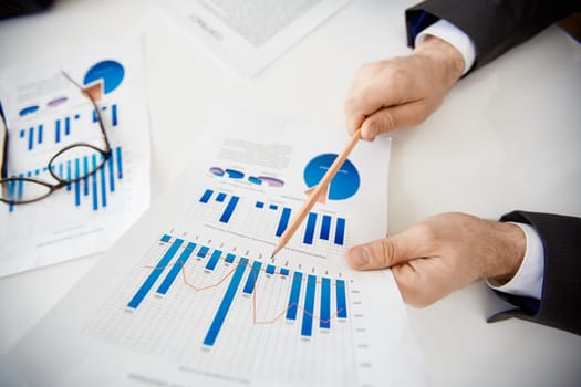 Businessman making financial report at meeting