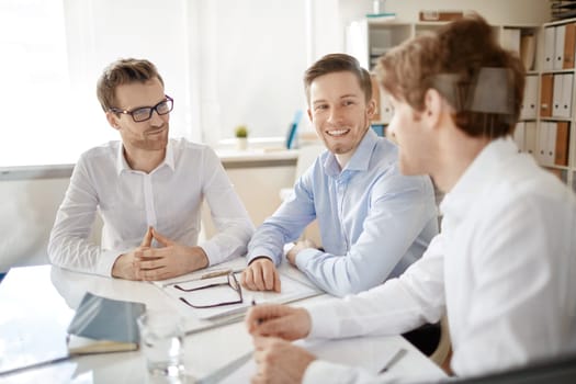 Group of businessmen discussing plans in office