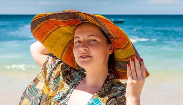 woman in hat on the beach. front view