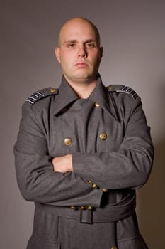 young man dressed as russian military, studio picture