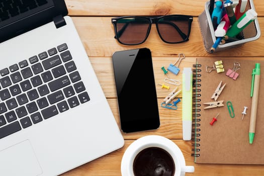 workplace with laptop coffee phone and notebook on wood desk