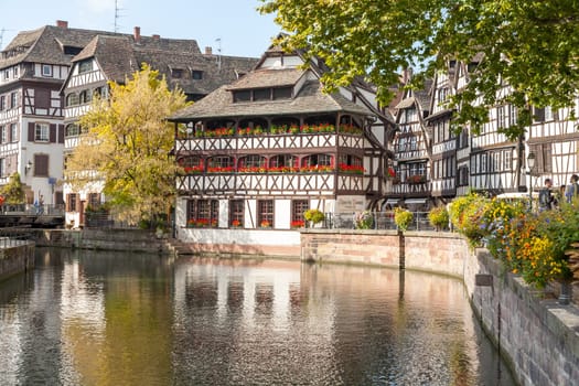 Strasbourg, water canal in Petite France area. timbered houses and trees in Grand Ile. Alsace, France.