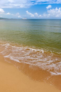 Beach on the tropical island. Clear blue water, sand and clouds. Beautiful vacation spot.