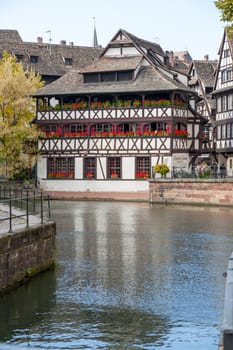 Strasbourg, water canal in Petite France area. timbered houses and trees in Grand Ile. Alsace, France.