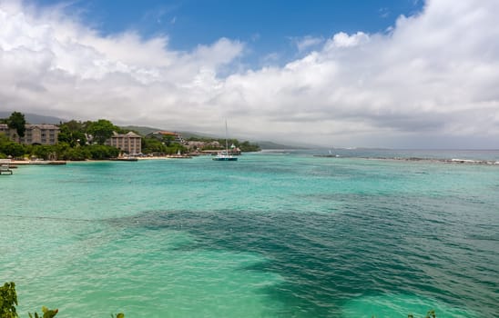 Beach on the tropical island. Clear blue water, blue sky. Beautiful vacation spot.